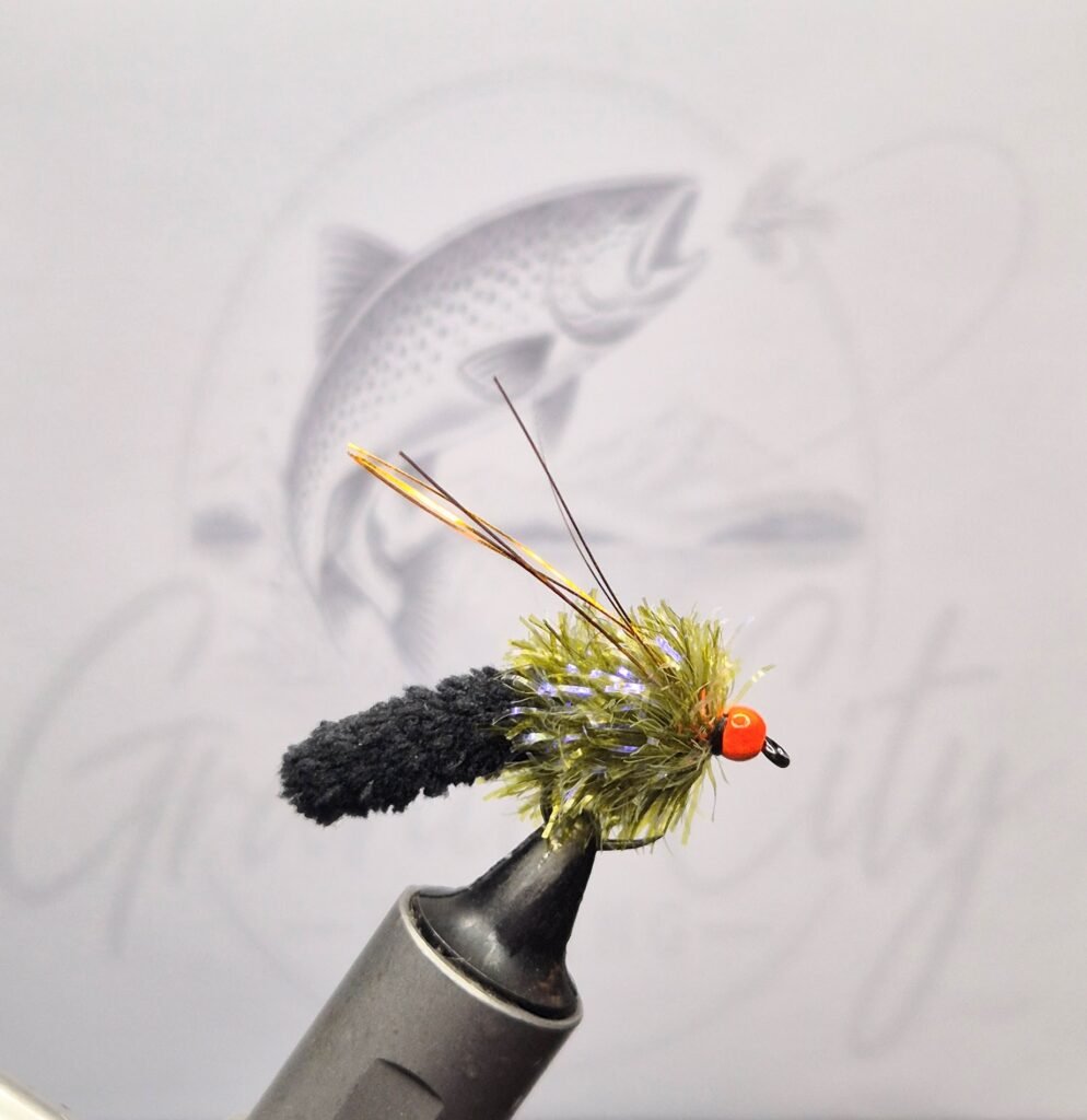 Ally Mop Fly barbless trout fly with black mop body, olive hackle and orange head