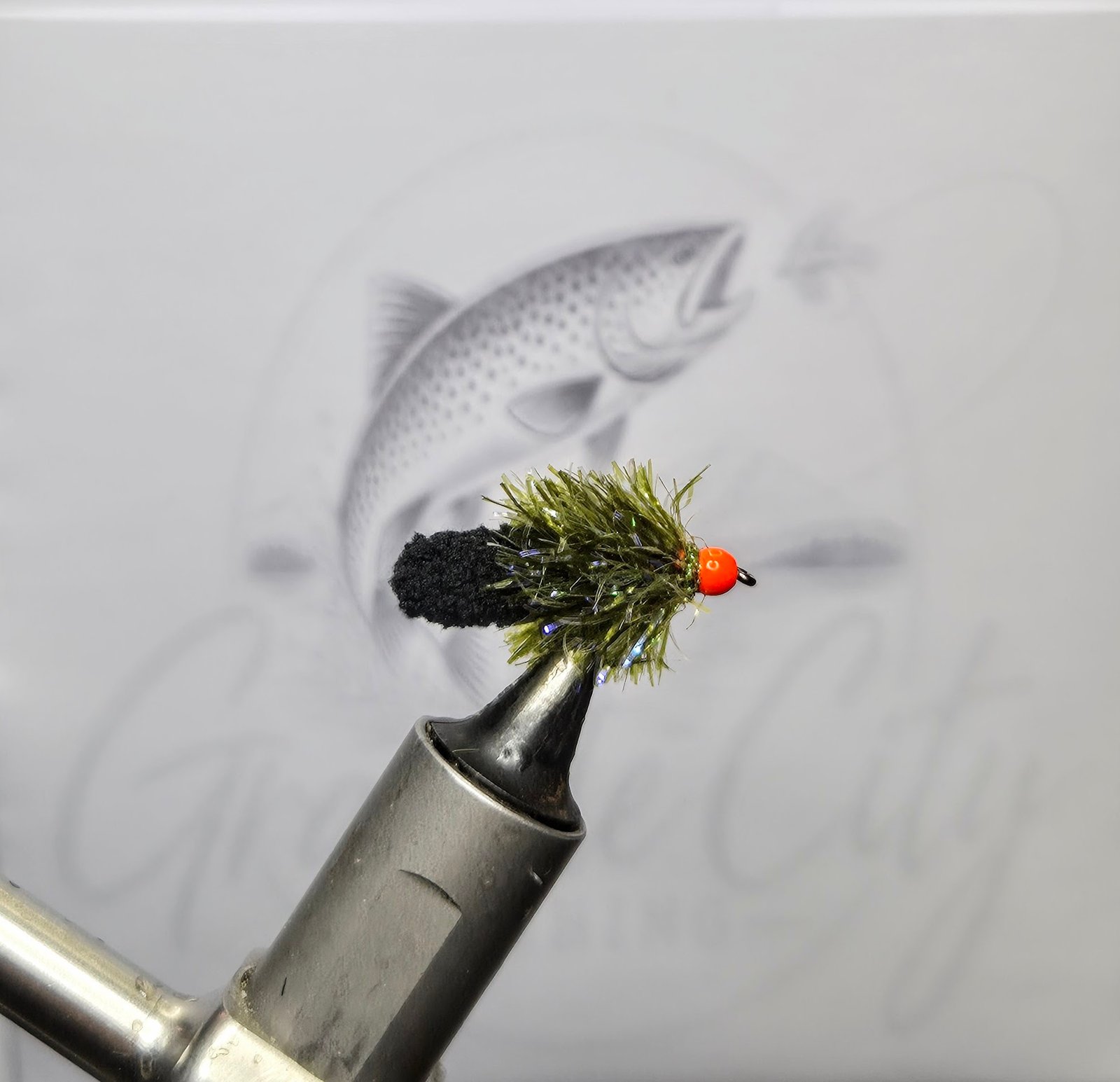 Olive and black Ally Mop Fly with orange head for trout fishing